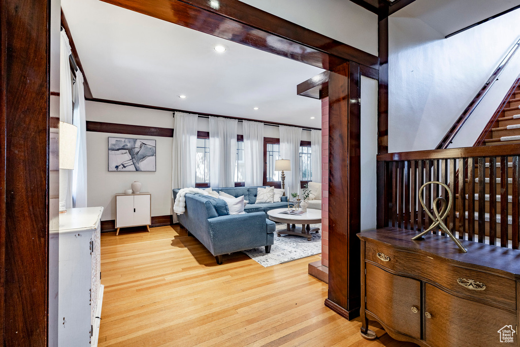 Living room with light wood-style flooring and recessed lighting