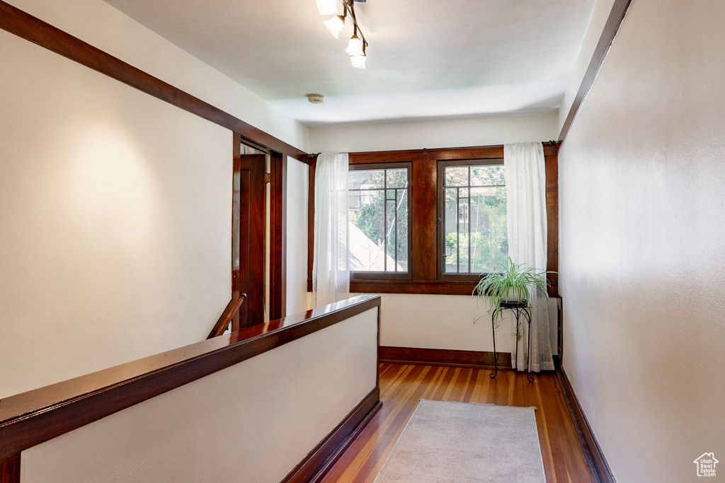 Hall featuring wood finished floors and baseboards