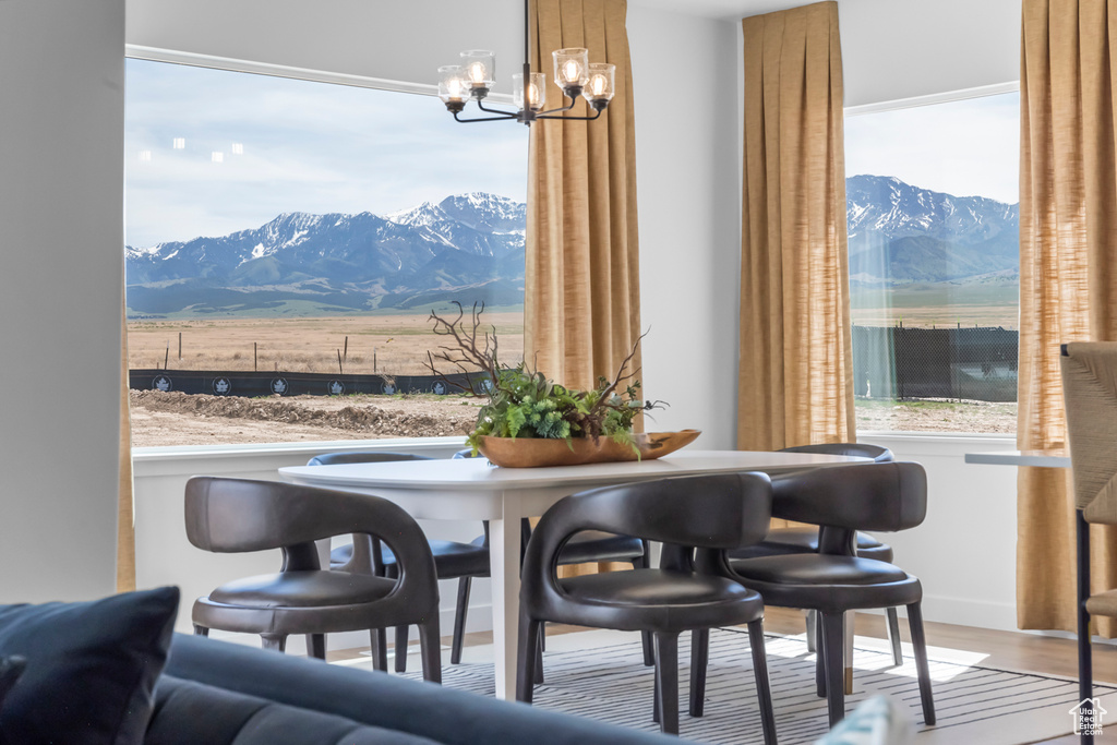 Dining room featuring a chandelier, a mountain view, and wood finished floors
