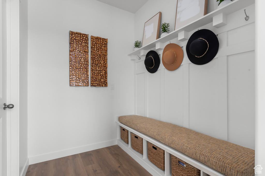 Mudroom featuring dark wood-style flooring and baseboards