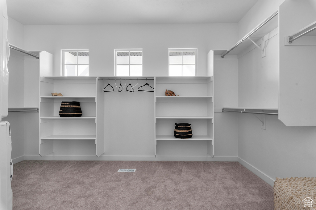 Walk in closet with carpet flooring