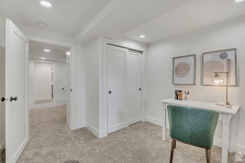 Hallway featuring light carpet, recessed lighting, and baseboards