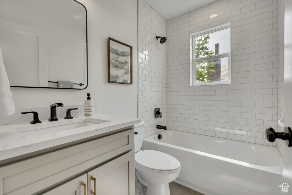 Full bath with vanity, toilet, and shower / bathtub combination