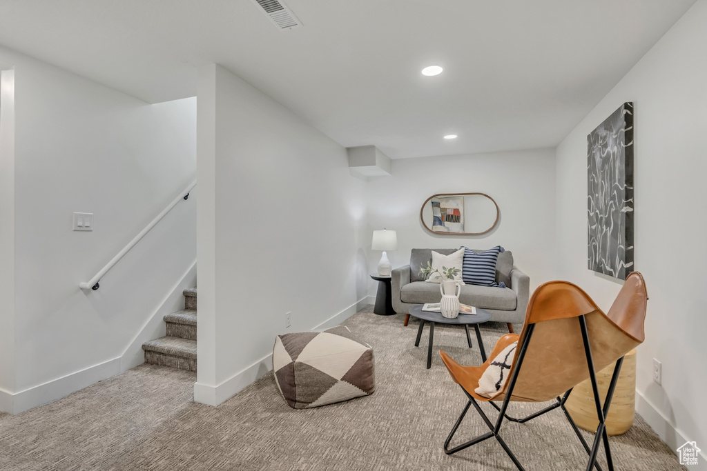 Living area with carpet, baseboards, stairway, and recessed lighting