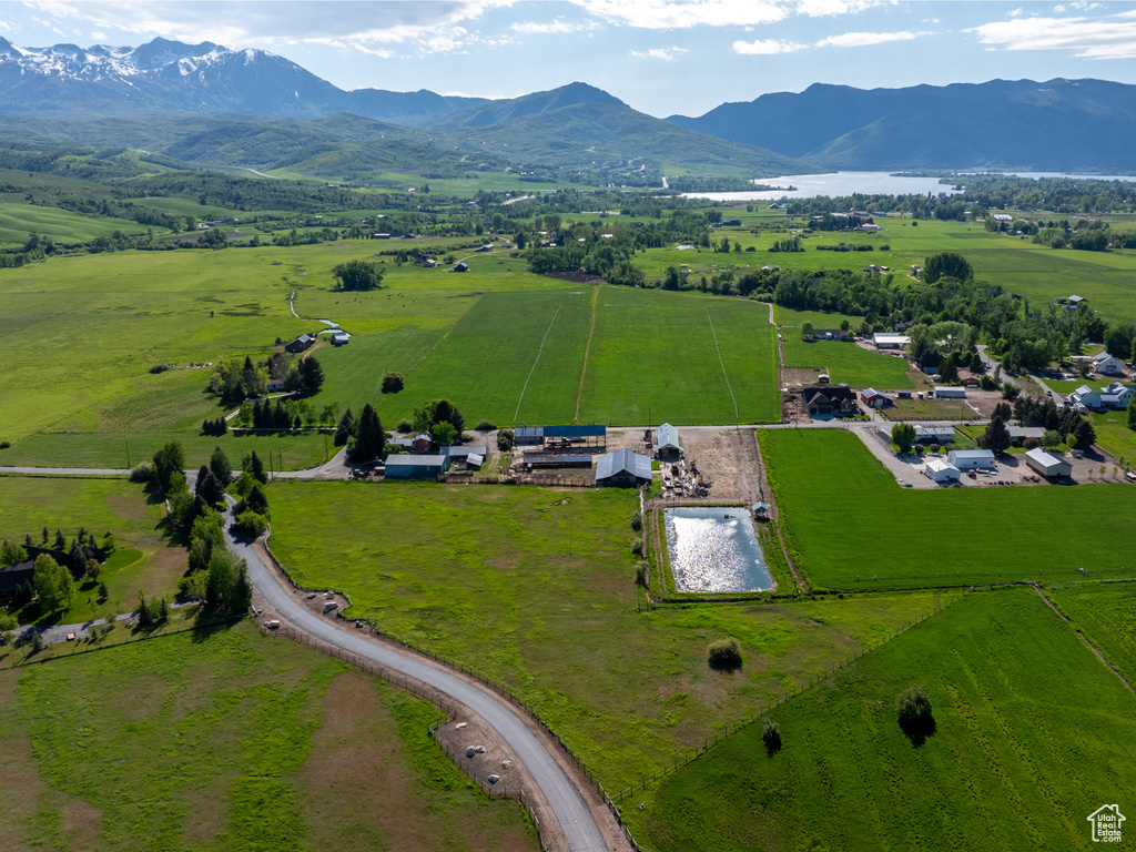 Aerial view of sparsely populated area with a pastoral area and a mountainous background