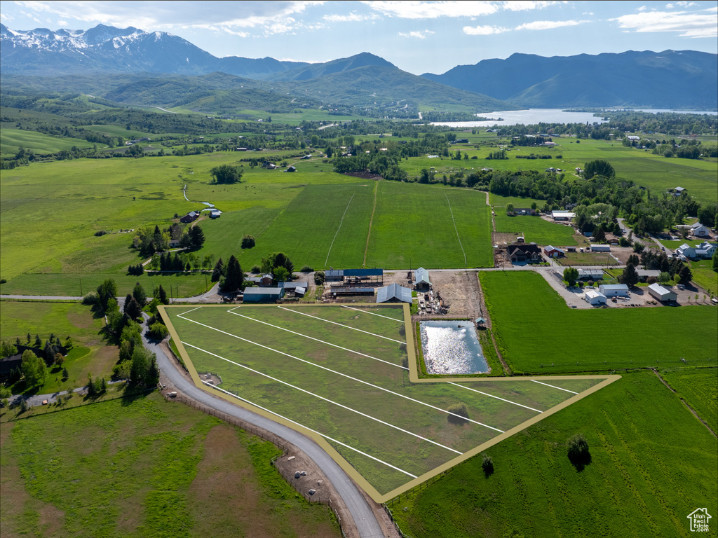 Aerial view of sparsely populated area featuring a mountain backdrop and a pastoral area