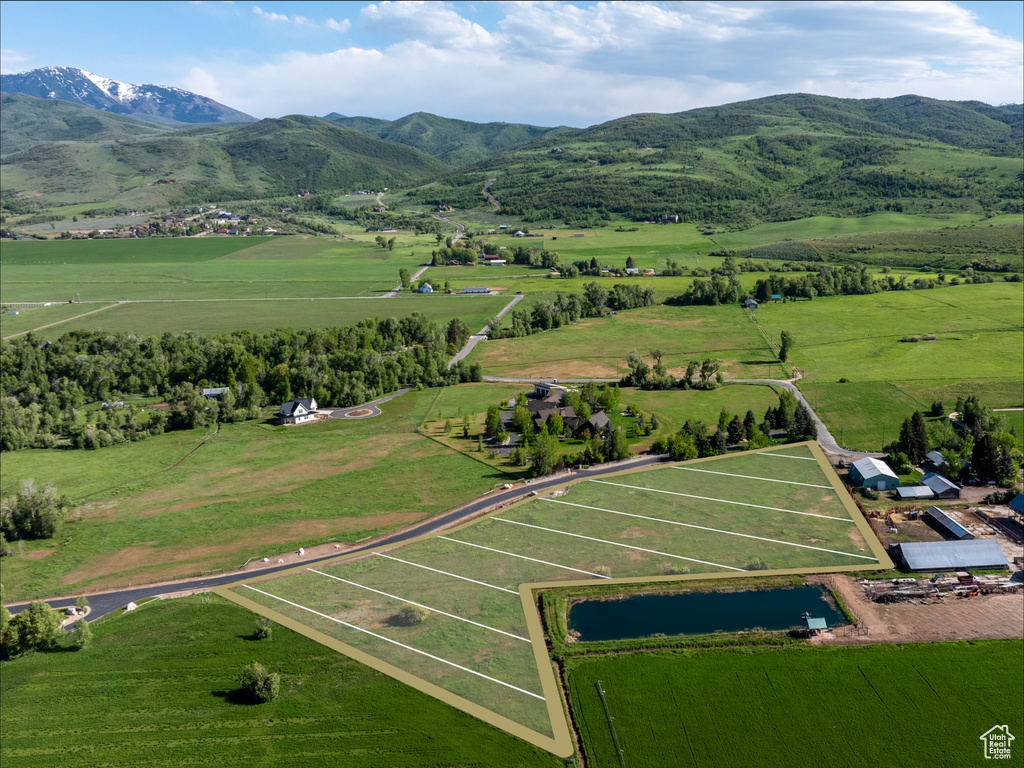 Aerial view of sparsely populated area featuring mountains and a pastoral area