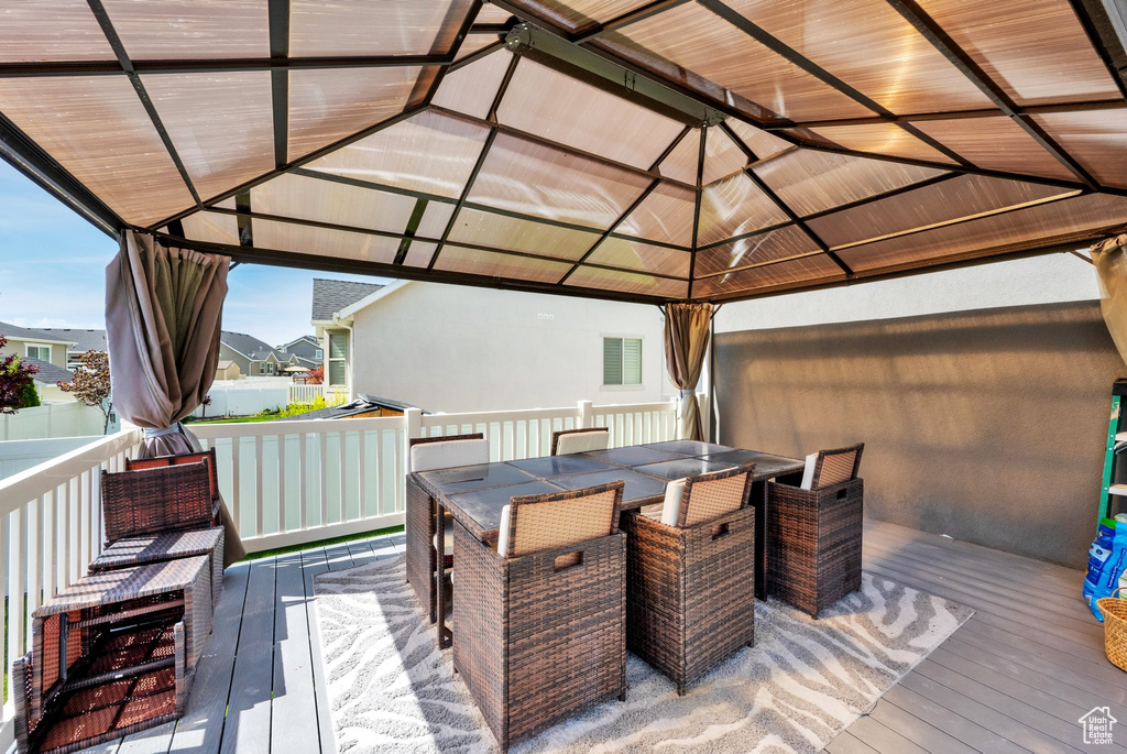 Wooden terrace with a gazebo and a residential view