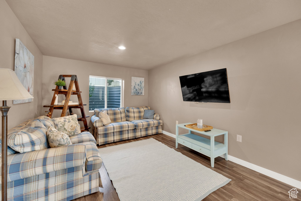 Living area with baseboards, wood finished floors, and recessed lighting