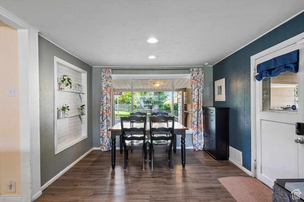 Dining space featuring wood finished floors, baseboards, and recessed lighting