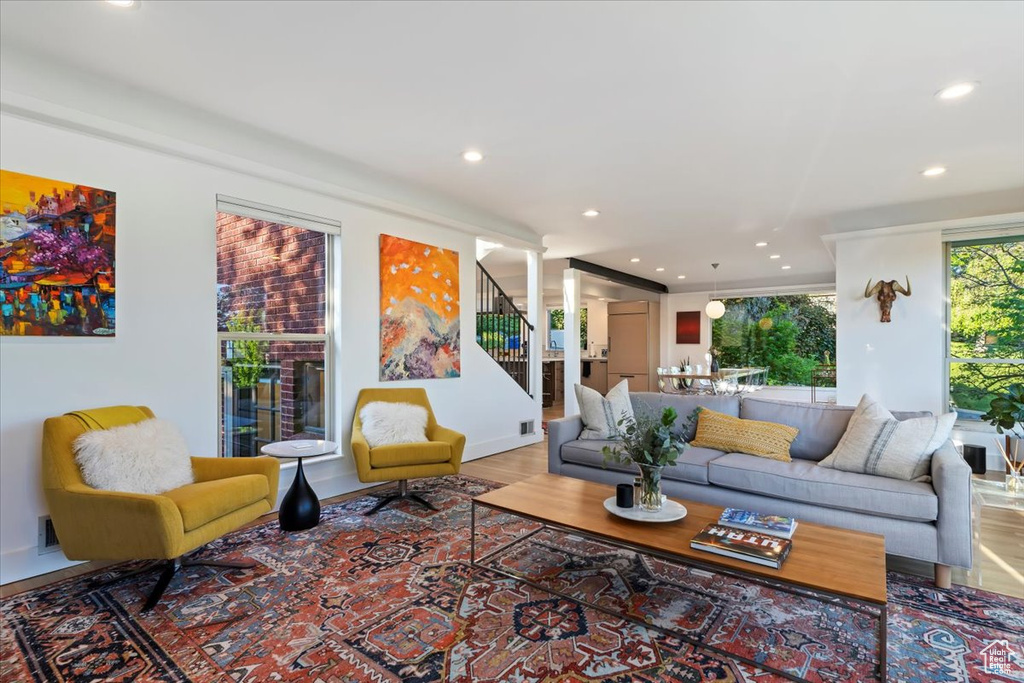 Living area featuring recessed lighting, stairway, wood finished floors, and baseboards