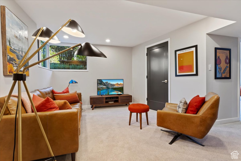 Carpeted living area featuring baseboards and recessed lighting