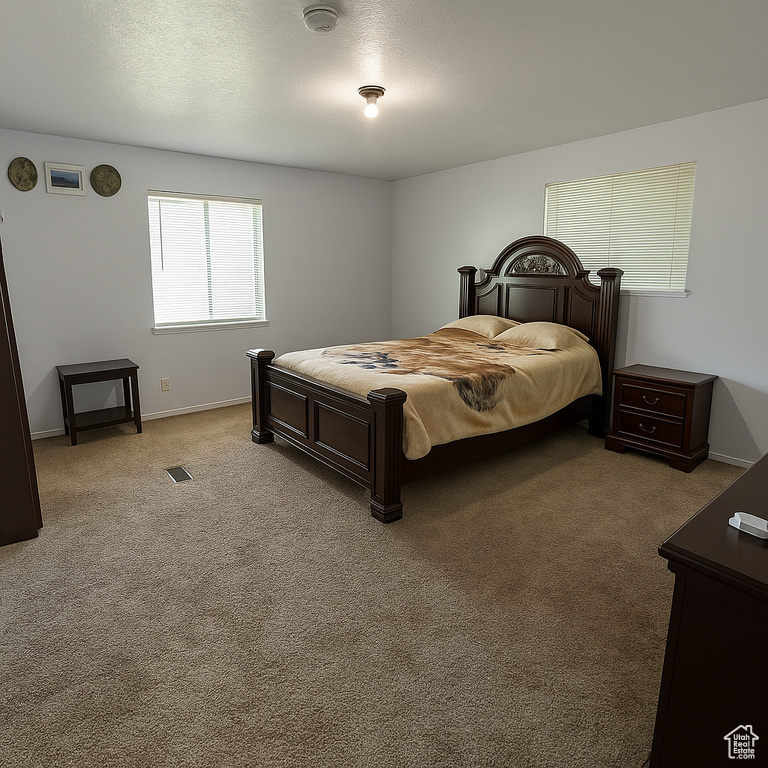 Bedroom featuring carpet floors and baseboards