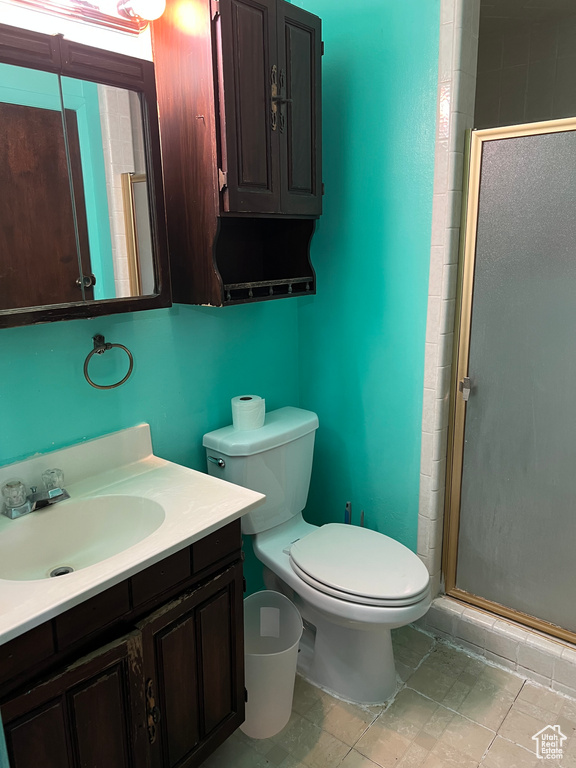 Full bathroom featuring vanity, a shower stall, and toilet