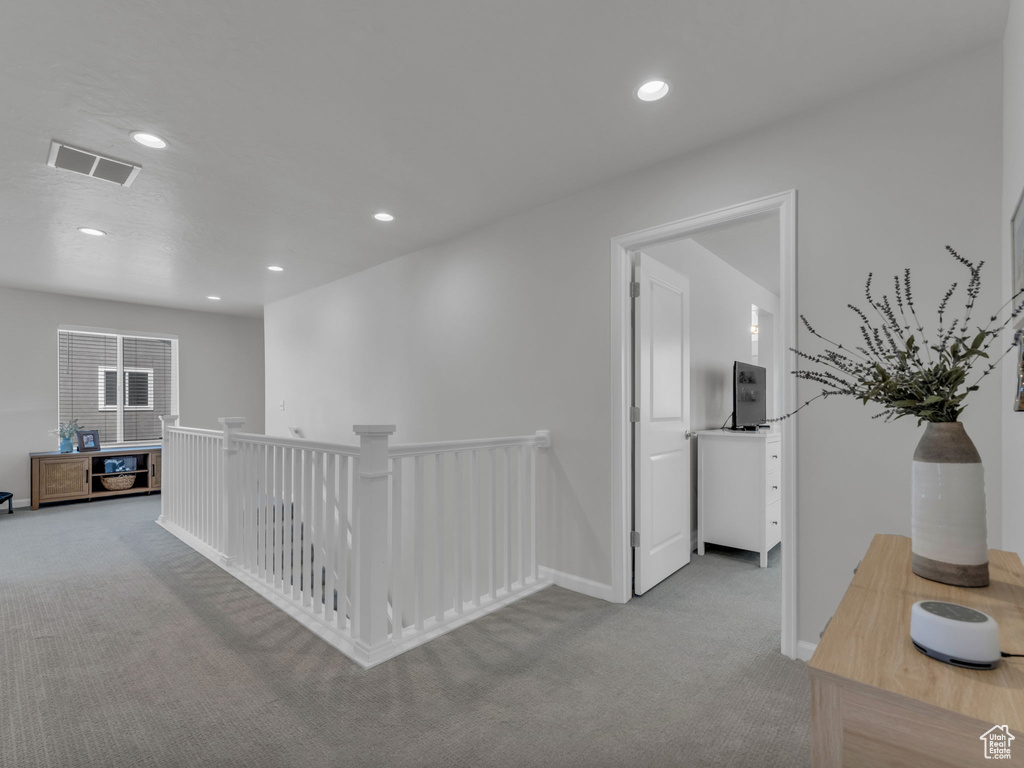 Hallway with carpet floors, an upstairs landing, recessed lighting, and baseboards
