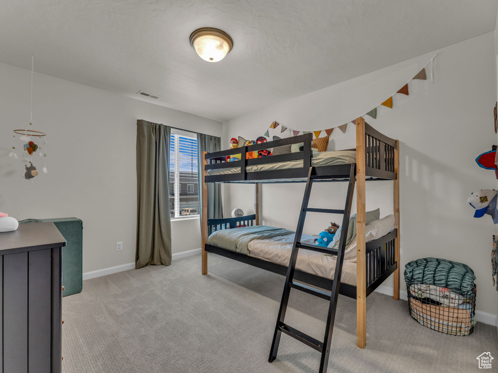 Bedroom featuring carpet flooring and baseboards