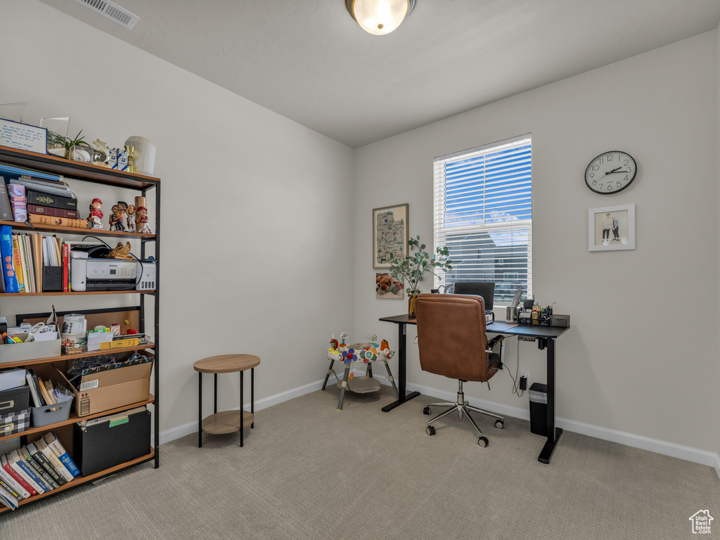 Home office featuring carpet floors and baseboards