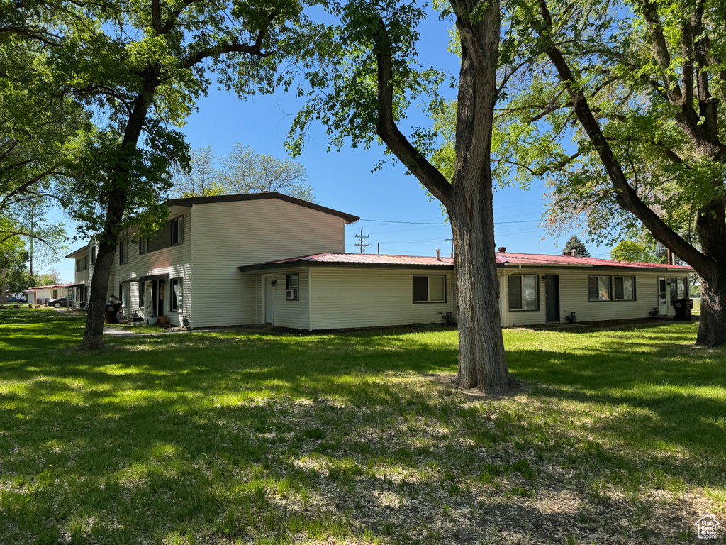 Rear view of house with a yard