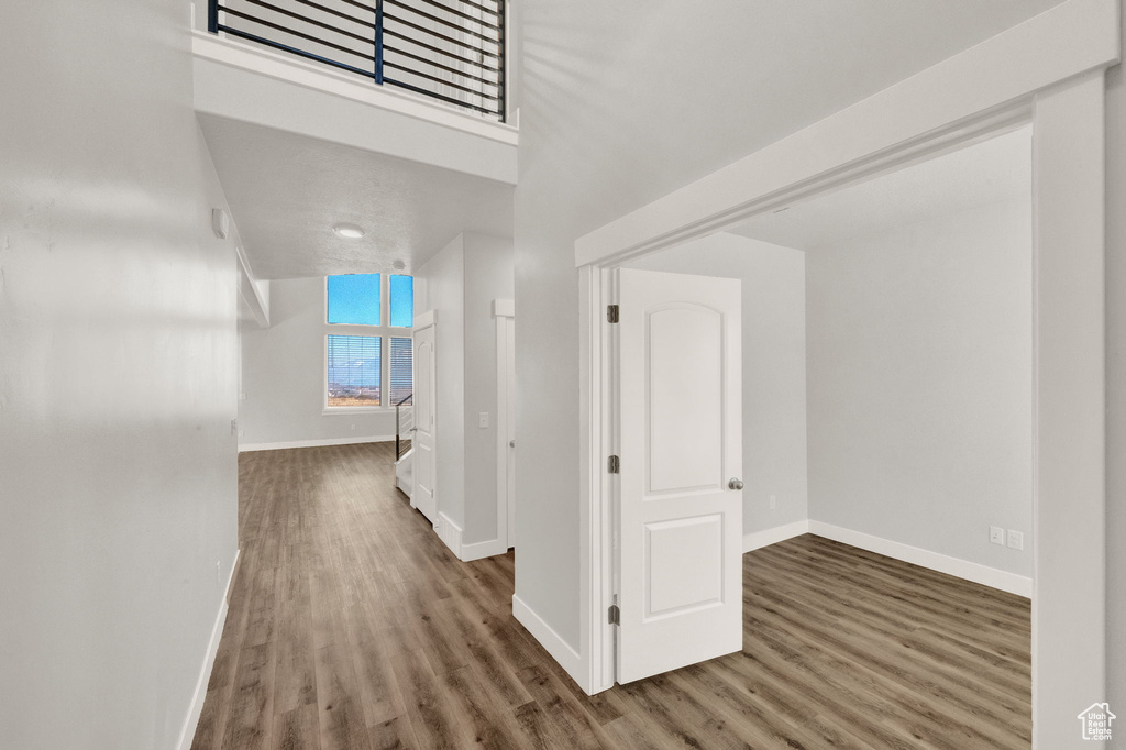 Corridor with baseboards and wood finished floors