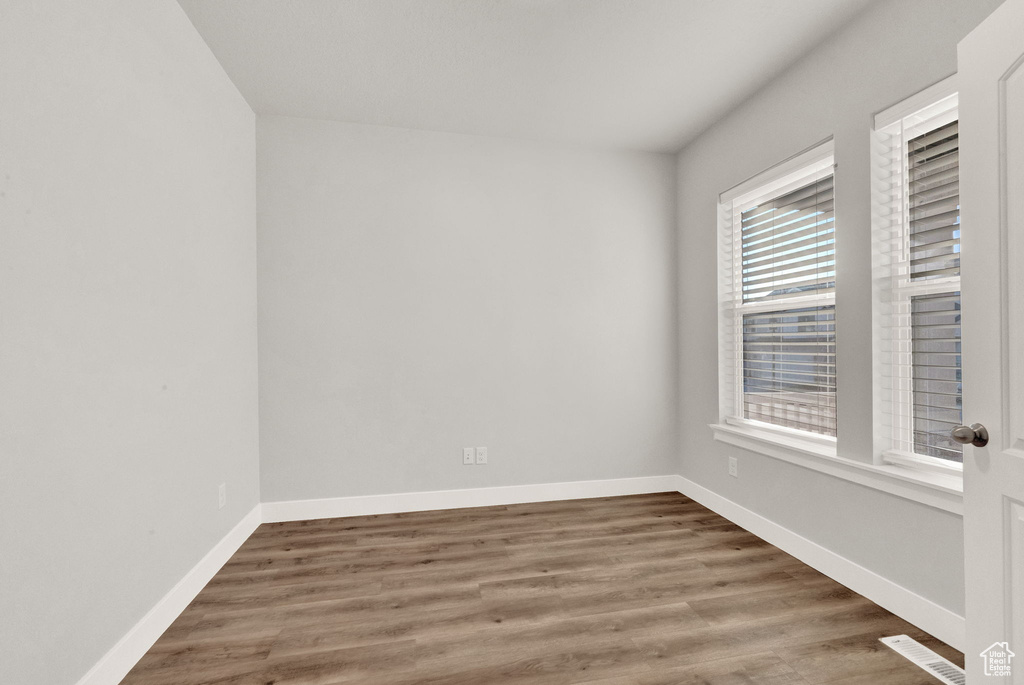 Unfurnished room featuring wood finished floors and baseboards