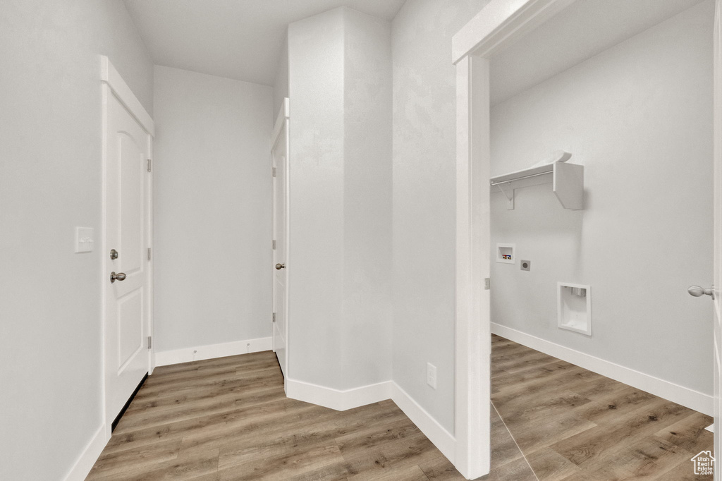 Hall featuring light wood finished floors and baseboards