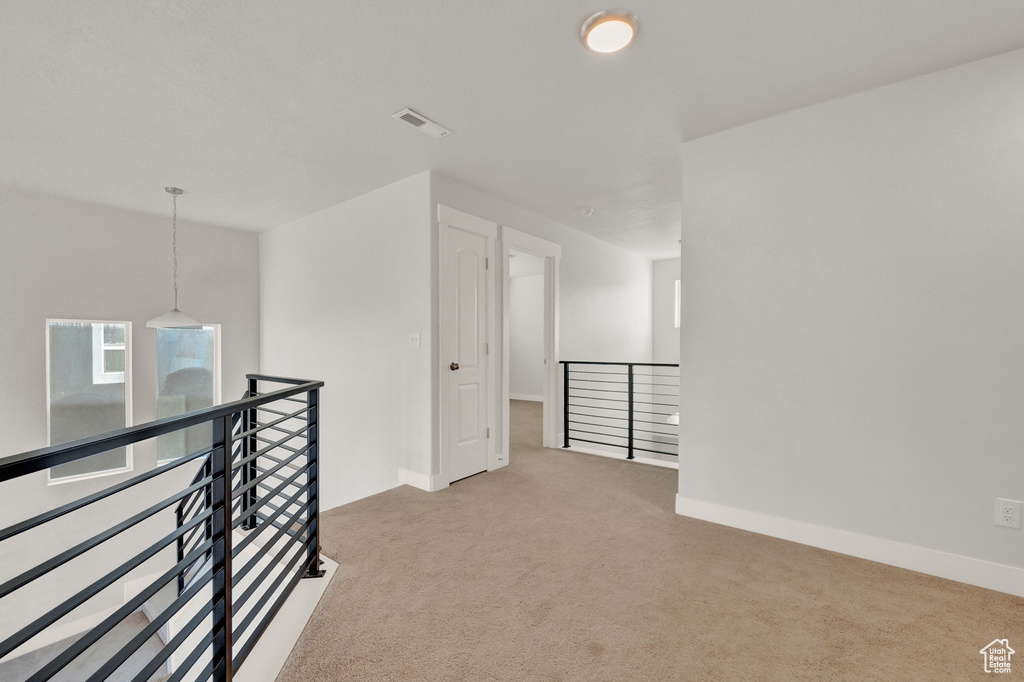 Empty room featuring carpet flooring and baseboards