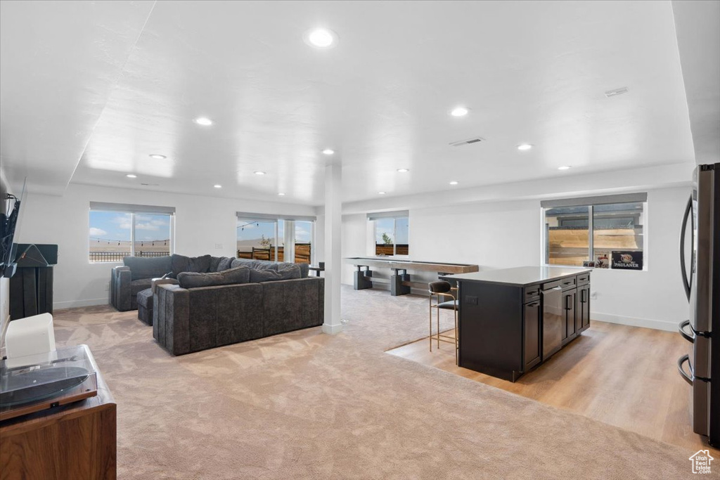 Living room with recessed lighting, baseboards, and light colored carpet