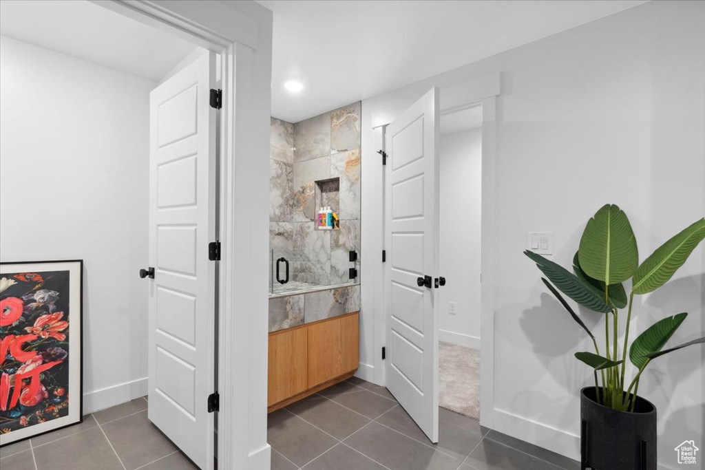 Bathroom with baseboards, a stall shower, tile patterned floors, recessed lighting, and vanity