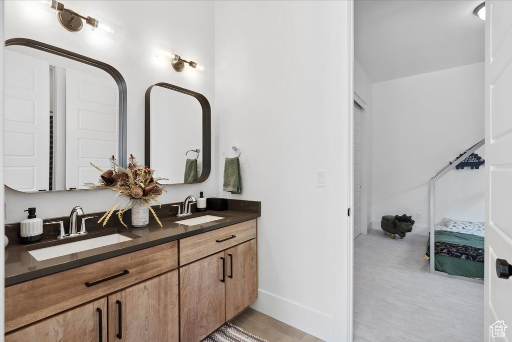 Ensuite bathroom with double vanity and baseboards