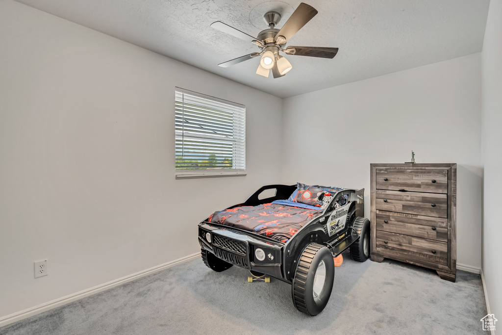 Bedroom featuring carpet floors, baseboards, and a ceiling fan