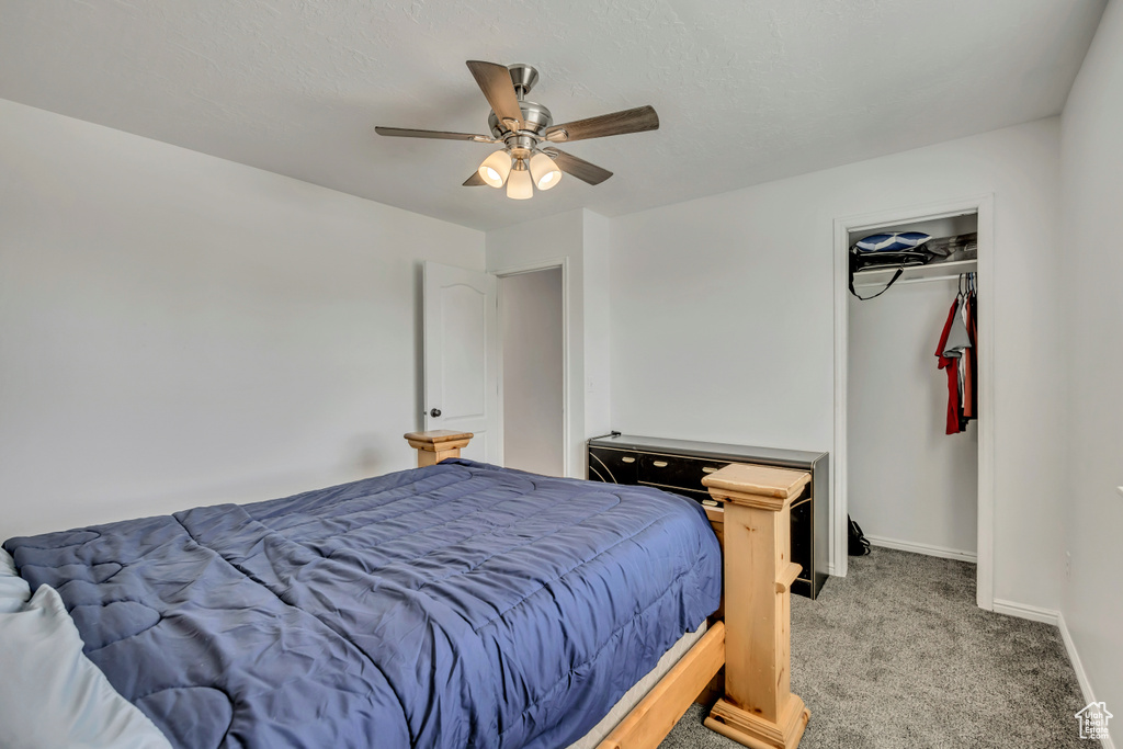 Carpeted bedroom with baseboards and ceiling fan