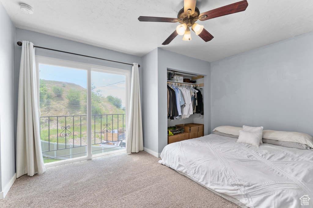 Carpeted bedroom with access to outside, baseboards, a closet, and ceiling fan