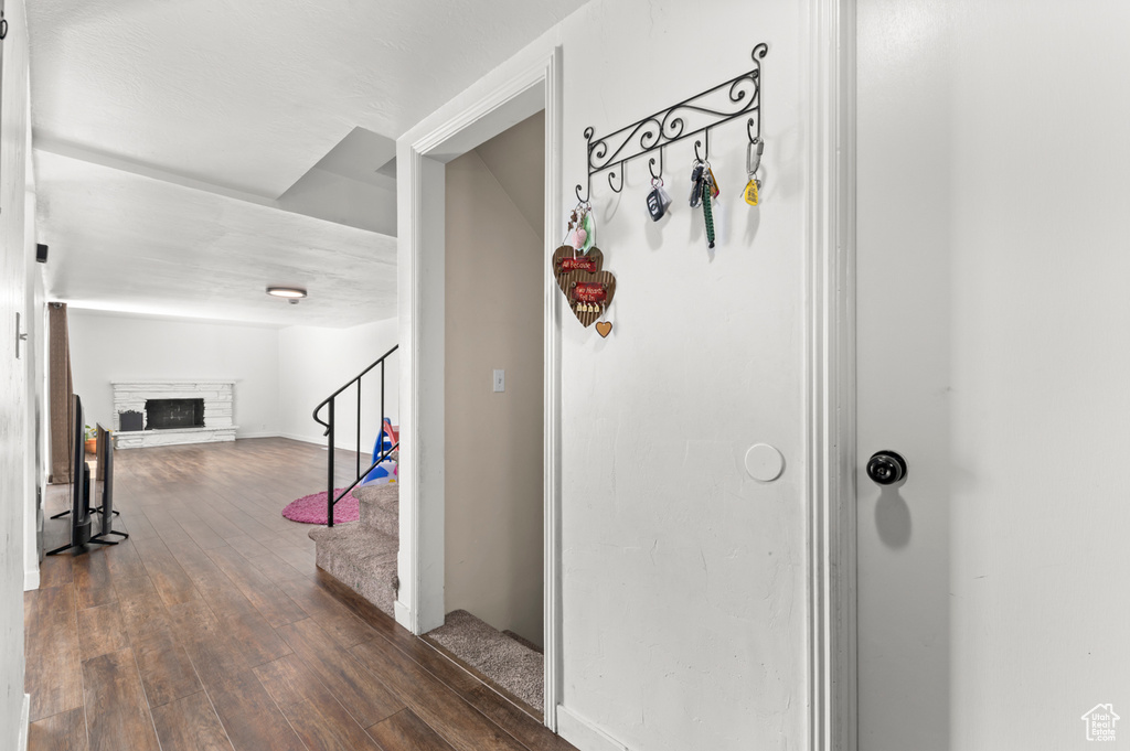 Hall with stairway and dark wood-style floors