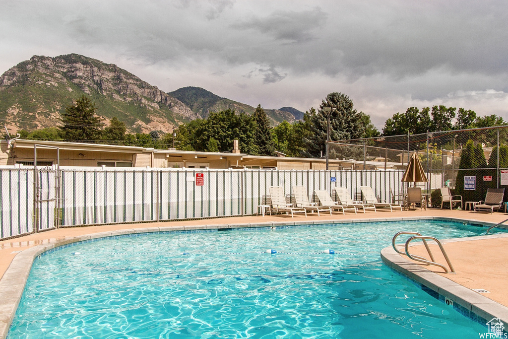 Community pool with a mountain view and a patio