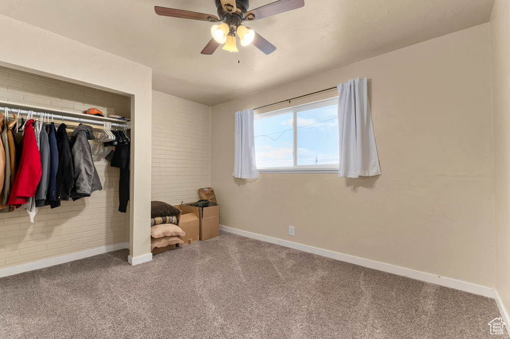 Unfurnished bedroom featuring baseboards, carpet flooring, a closet, and a ceiling fan
