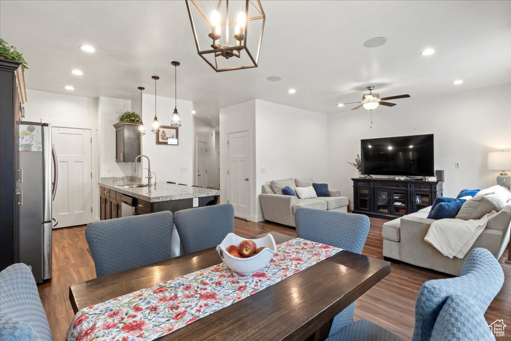 Dining space featuring a ceiling fan, recessed lighting, wood finished floors, and a chandelier