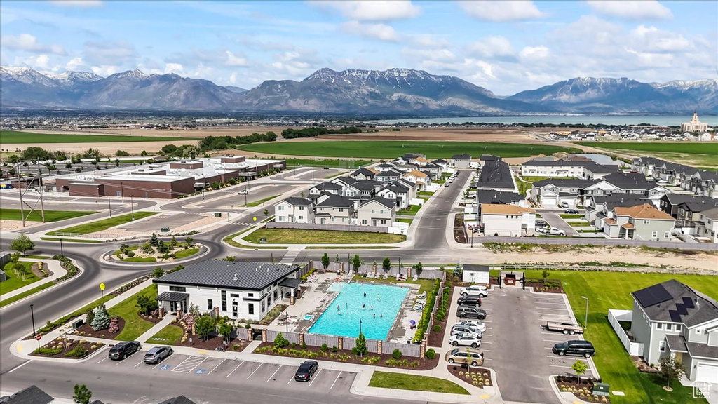 Aerial view of residential area featuring a water and mountain view and a pool