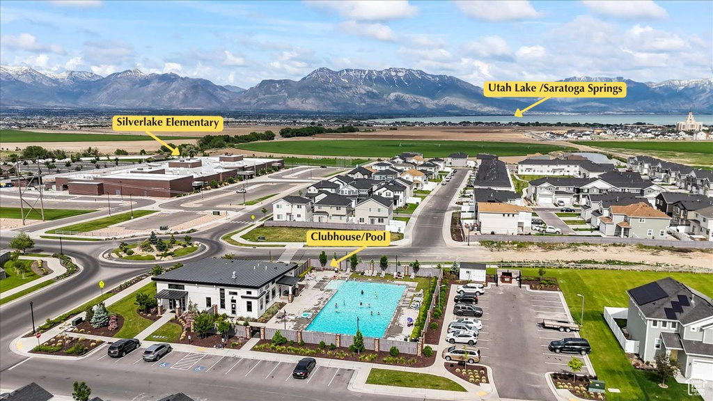 Aerial view of a pool area and a water and mountain view