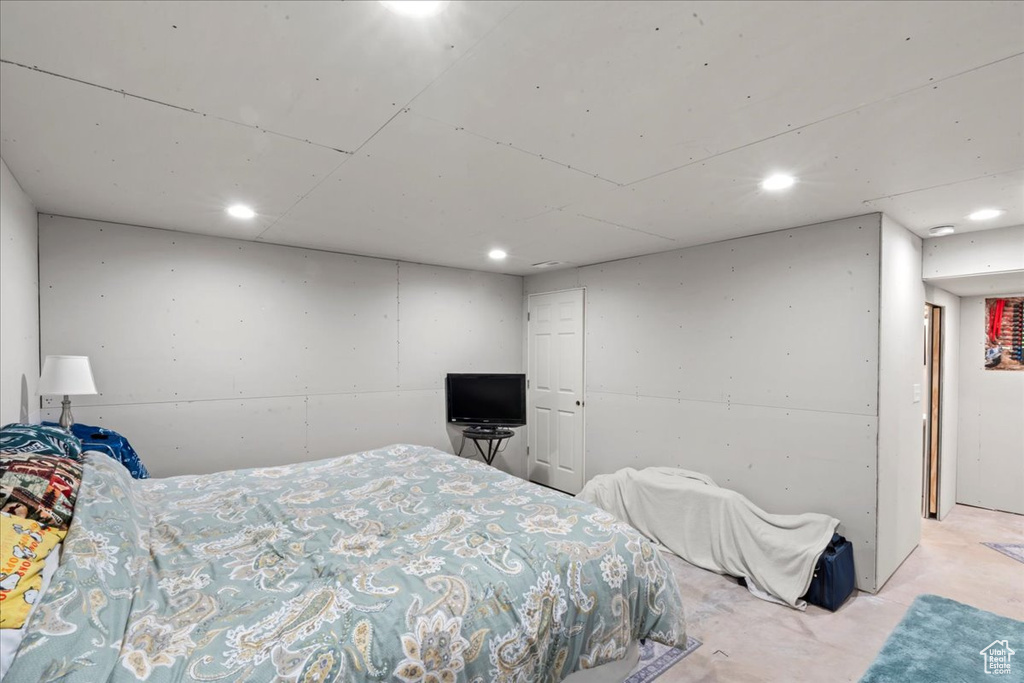 Bedroom with recessed lighting and unfinished concrete floors