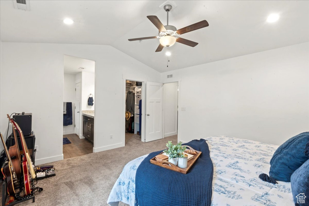 Carpeted bedroom featuring lofted ceiling, a spacious closet, ceiling fan, baseboards, and recessed lighting