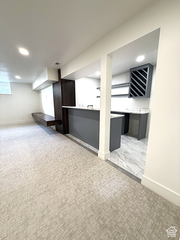 Bar area featuring light carpet, baseboards, and recessed lighting