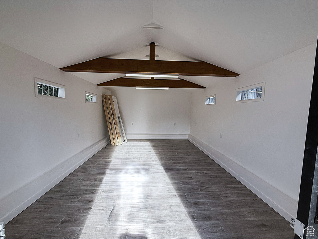Empty room featuring baseboards and dark wood finished floors