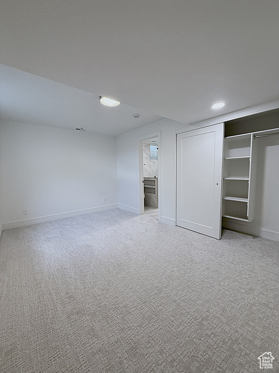 Finished basement featuring light carpet, baseboards, and recessed lighting