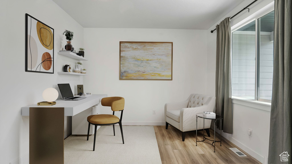 Home office featuring light wood finished floors and baseboards