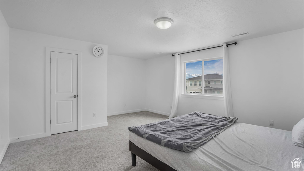 Carpeted bedroom featuring baseboards