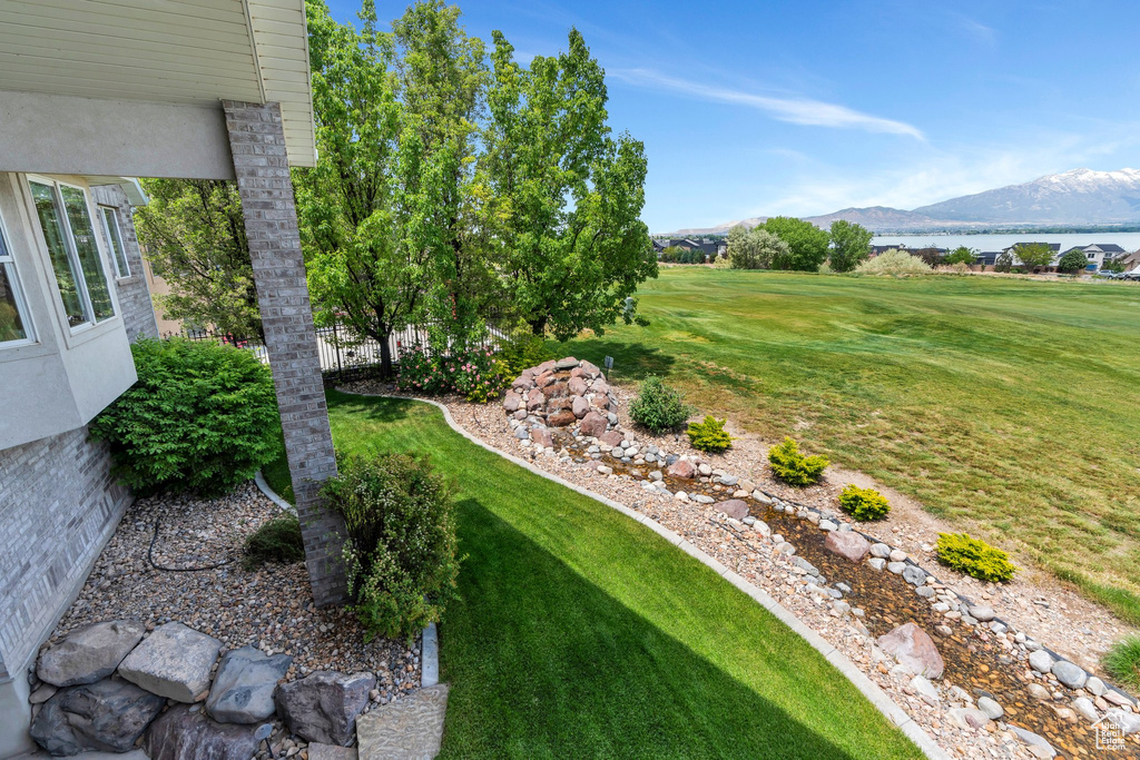 View of green lawn featuring a mountain view