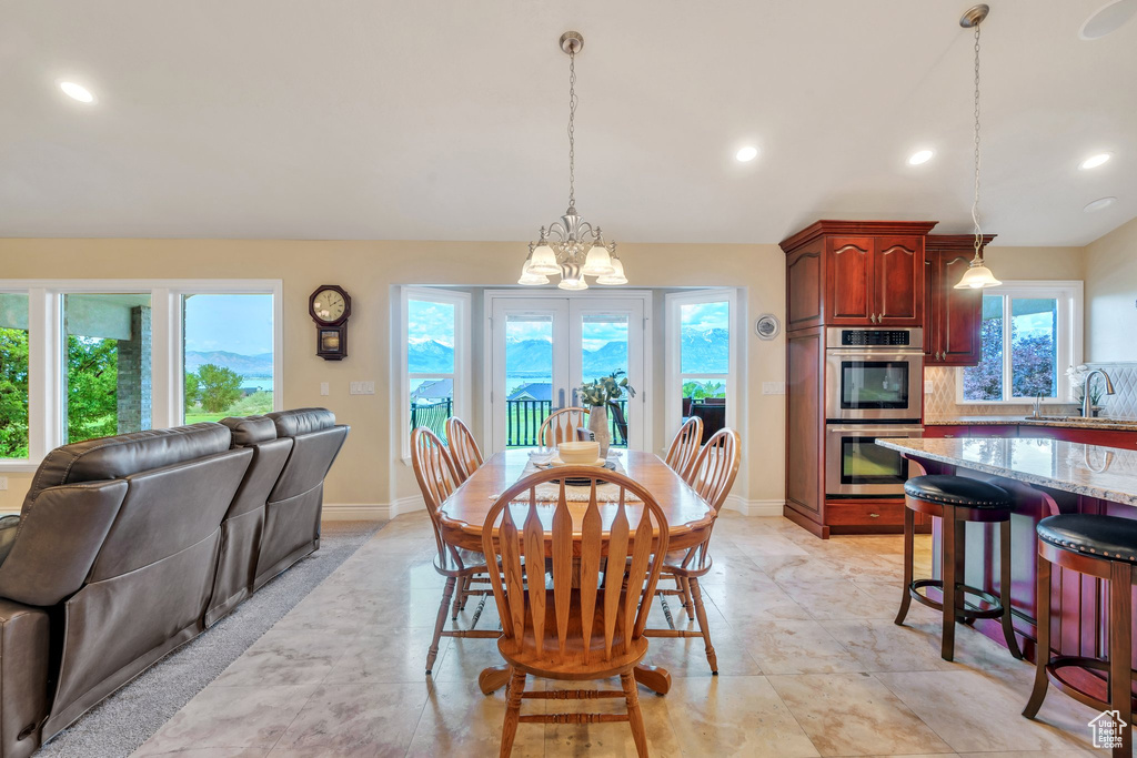 Dining area featuring a chandelier, baseboards, and recessed lighting