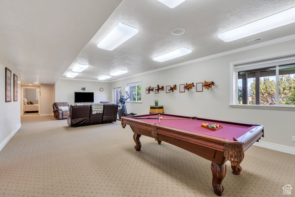 Playroom featuring carpet floors, baseboards, billiards, a textured ceiling, and crown molding