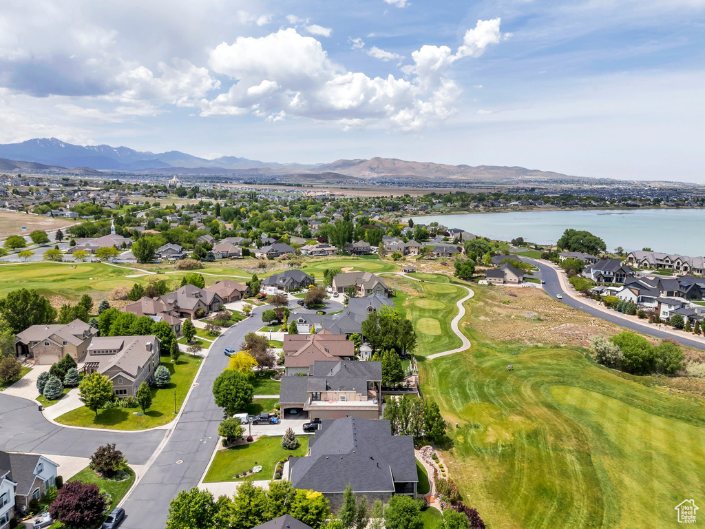 Aerial perspective of suburban area with a water and mountain view and a golf course