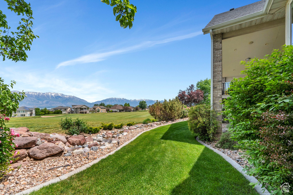 View of grassy yard featuring a mountain view